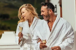 Couple wearing bathrobes in balcony