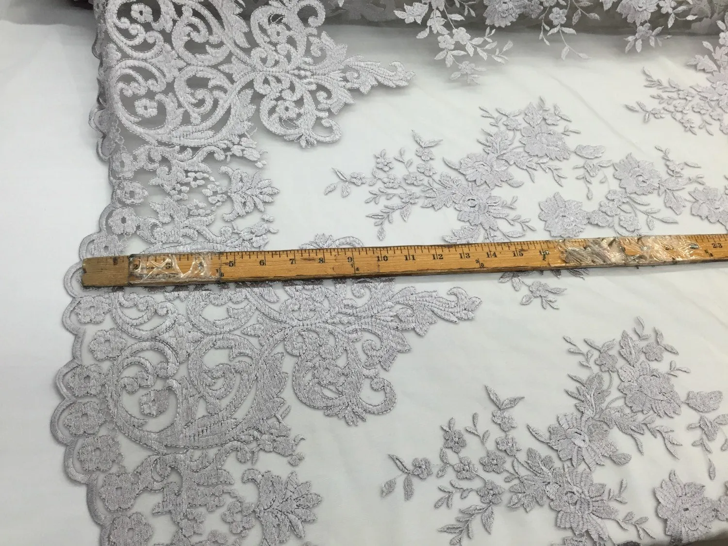 Silver/gray flowers embroider on a 2 way stretch mesh lace. Wedding/Bridal/Prom/Nightgown fabric-apparel-dresses-fashion-Sold by the yard.